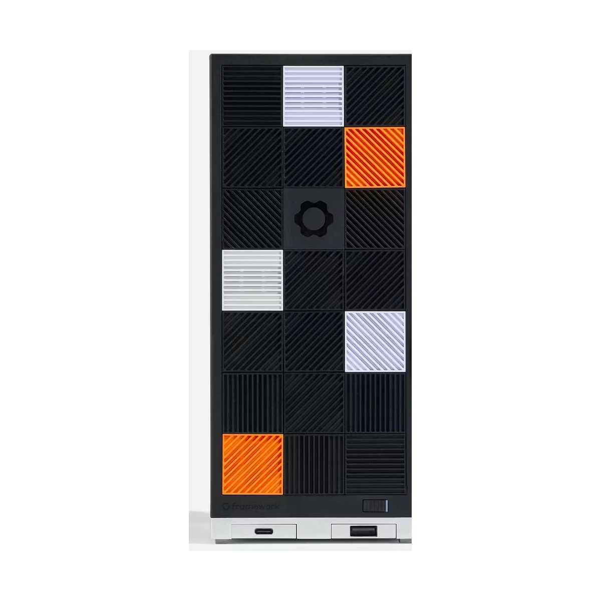 Framework Desktop shown from the front with its black side panel and modular front tiles